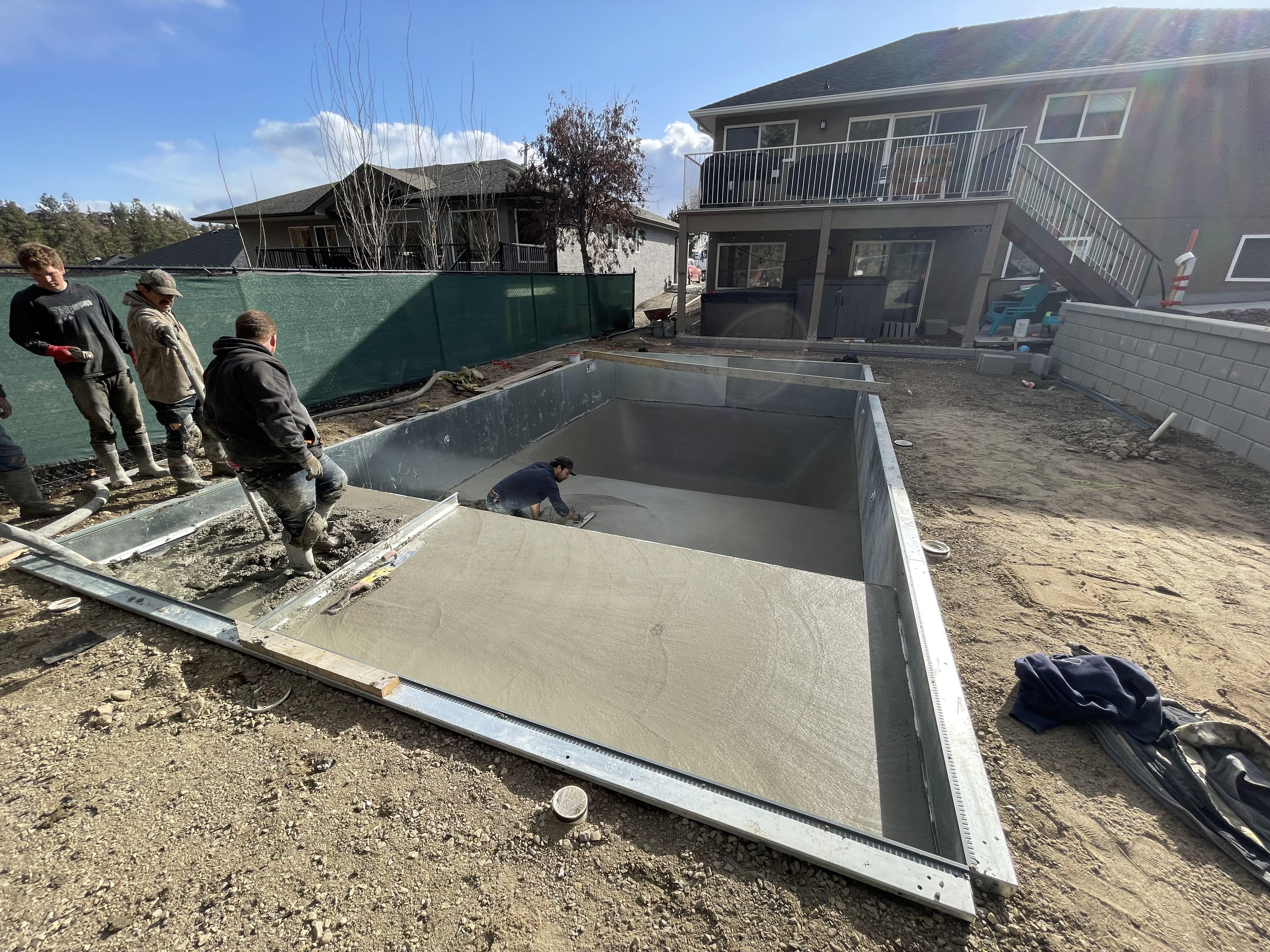 Laser-guided equipment preparing soil for patio base and drainage