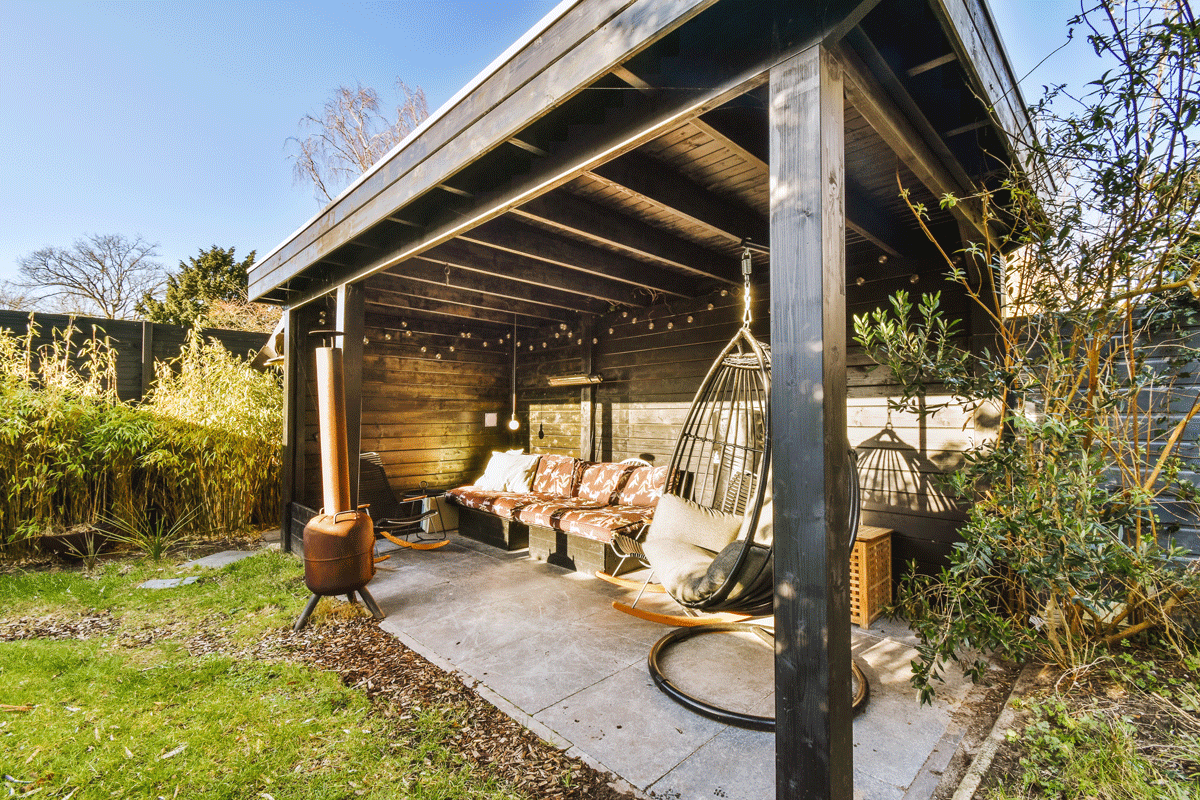 The-Outdoor-Room-is-2025-Must-Have-featured - Exquisite Lawn & Landscaping Modern outdoor room with lounge seating, pergola, and fire table | Exquisite Lawn & Landscaping